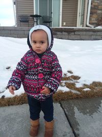 Portrait of cute girl standing in snow