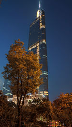 Low angle view of illuminated modern buildings against clear sky