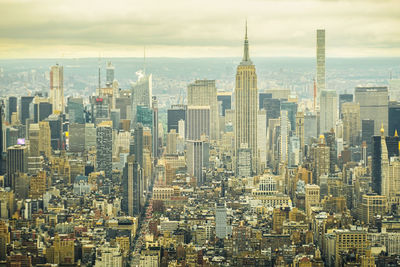 Aerial view of modern buildings in city against sky