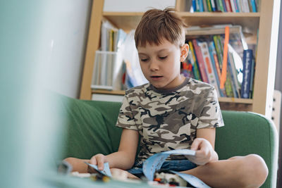 Boy reading book at home