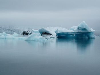 Scenic view of iceberg on foggy lake