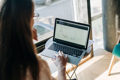 Midsection of woman using laptop