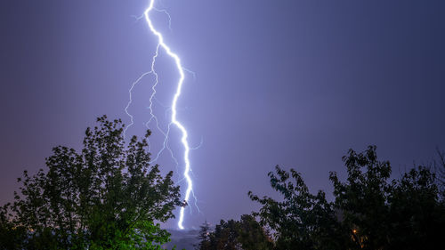 Low angle view of lightning in sky at night