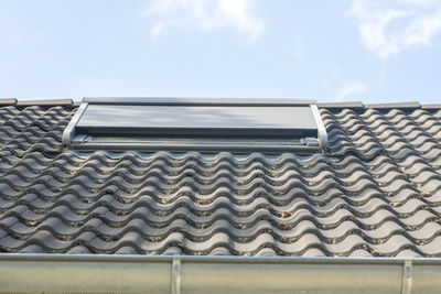 Low angle view of roof and building against sky