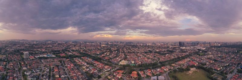 High angle shot of townscape against sky at sunset