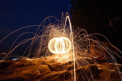 Firework display against sky at night