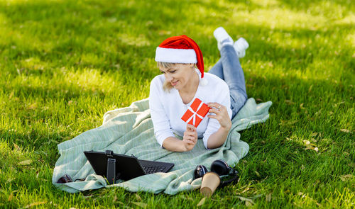 Cute female ordering presents on laptop. online shopping. new year