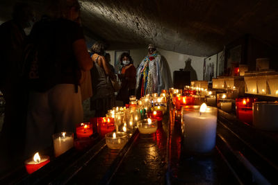 View of illuminated candles in temple