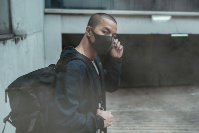 Portrait of man standing in parking lot