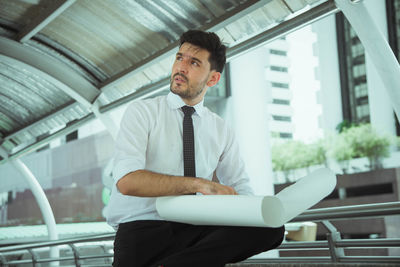 Businessman with paper sitting in office