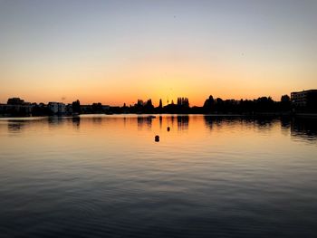 Scenic view of lake against sky during sunset