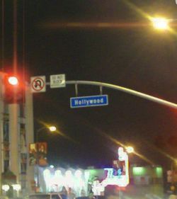 Low angle view of illuminated sign in city at night