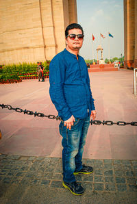 Portrait of young man wearing sunglasses standing outdoors