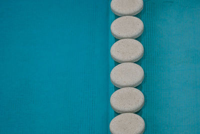 Directly above shot of eggs on blue wall