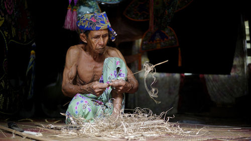 Man working in traditional clothing