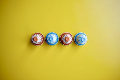 High angle view of objects on yellow background