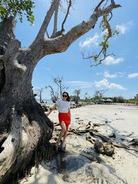 Rear view of woman standing on beach