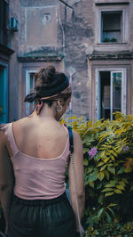 Woman standing by building