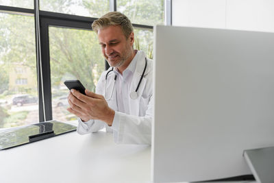 Young man using digital tablet in office