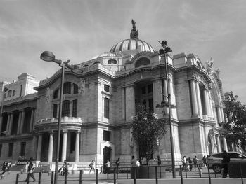 Tourist at palacio de bellas artes against sky
