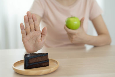 Midsection of woman holding ice cream