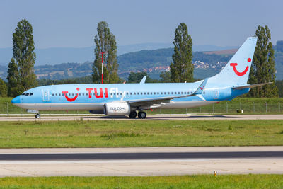 Airplane on runway against clear sky