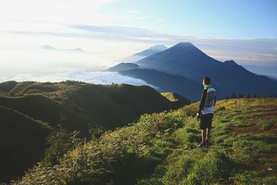 Full length of man standing on mountain against sky