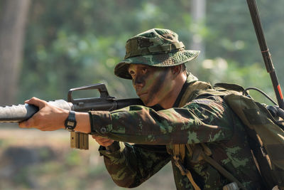 Soldier holding gun outdoors