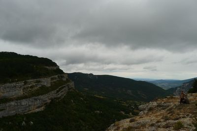 Scenic view of mountains against cloudy sky