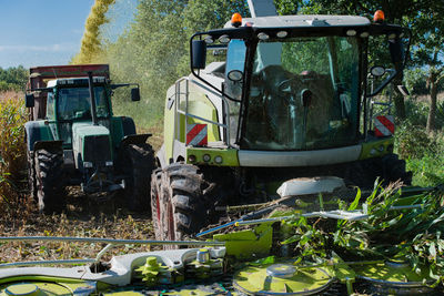 Tractors by plants in farm