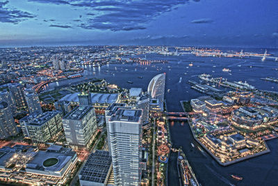 High angle view of city by river against buildings