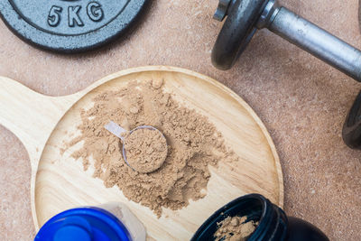 High angle view of chalk powder by dumbbells on floor