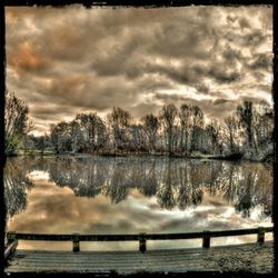 Scenic view of lake against cloudy sky