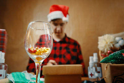 Midsection of man in drinking glass