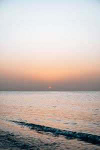 Scenic view of sea against clear sky during sunset