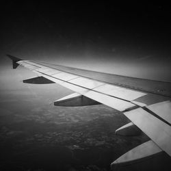 Cropped image of airplane flying in sky