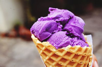 Close-up of purple ice cream in cone