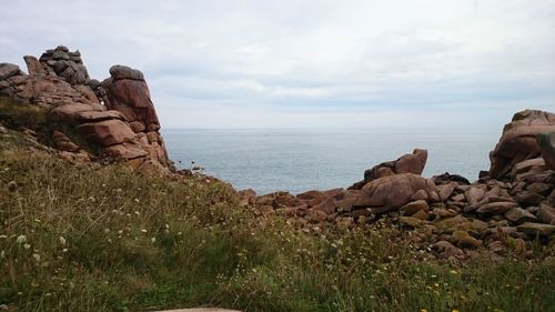 Rock formations by sea against sky