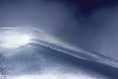 Low angle view of snow against sky