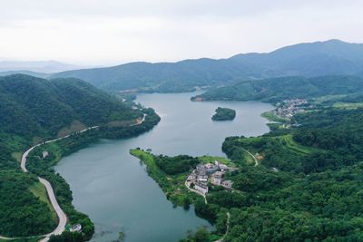 High angle view of river amidst mountains against sky