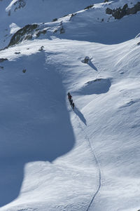 People skiing on snowcapped mountain