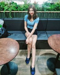 Portrait of a smiling young woman sitting on seat