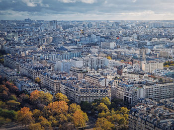 Paris cityscape view from the eiffel tower height, france. fall season scene with colored trees