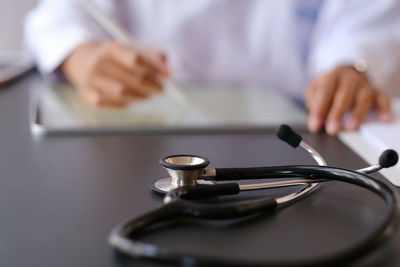 Close-up of man holding hands on table