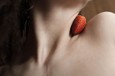 Close-up of woman with red berries