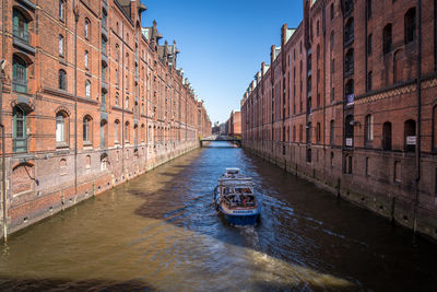 View of canal amidst buildings in city