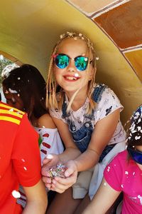 Low angle view of women sitting on sunglasses