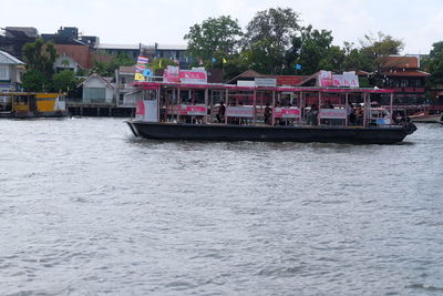 Boats in river with buildings in background