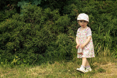 Portrait of girl standing on grass