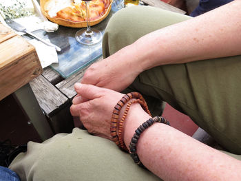 Linked hands of a woman sitting on a terrace